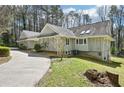Back exterior showing a winding driveway, generous backyard, and access to a lower level entrance at 4859 Clark Lake Nw Way, Acworth, GA 30102
