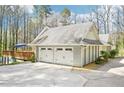 Spacious three-car garage with access to an upper level deck and surrounding greenery at 4859 Clark Lake Nw Way, Acworth, GA 30102