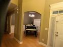 Welcoming entryway with hardwood floors, elegant chandelier, and arched doorways adding charm at 1162 Mason Lee, Loganville, GA 30052