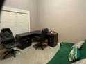 Well-lit home office featuring an executive desk setup and comfortable seating for a productive workspace at 1162 Mason Lee, Loganville, GA 30052