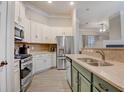 Spacious kitchen with stainless steel appliances, ample cabinet space, and a view into the adjacent living area at 1910 Cedar Glenn Way # 4401, Atlanta, GA 30339