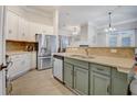Bright kitchen featuring white cabinets, stainless steel appliances, and a peninsula with counter seating at 1910 Cedar Glenn Way # 4401, Atlanta, GA 30339