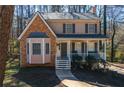 Attractive two-story home with brick and siding, a front porch, and a well-manicured lawn at 23 Peggy Nw Ct, Marietta, GA 30064