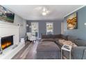 Inviting living room with a brick fireplace, gray walls, hardwood floors, and lots of natural light at 23 Peggy Nw Ct, Marietta, GA 30064