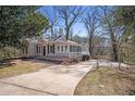 Inviting home features a long driveway, classic design, and peaceful surroundings at 495 Hutchens Se Rd, Atlanta, GA 30354