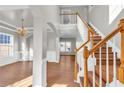 Grand foyer with hardwood floors, soaring ceilings, and a staircase with wood railings at 720 Goldenrod Way, Norcross, GA 30093