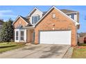 Lovely brick house with a two-car garage and a beautifully maintained front yard at 720 Goldenrod Way, Norcross, GA 30093