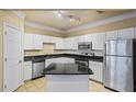 Well-lit kitchen with white cabinetry, granite countertops and stainless steel appliances at 1850 Cotillion Dr # 3222, Atlanta, GA 30338