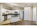 Bright kitchen featuring stainless steel appliances, granite counters, tile floors and a center island at 1850 Cotillion Dr # 3222, Atlanta, GA 30338