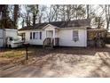 Exterior view of a modest one-story home with small front porch and an old truck to the side at 241 Killian St, Canton, GA 30114