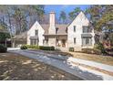Elegant home with manicured hedges, lush lawn, and a charming front entryway at 333 Pineland Nw Rd, Atlanta, GA 30342