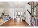 Bright and open foyer featuring hardwood floors and a modern chandelier at 333 Pineland Nw Rd, Atlanta, GA 30342