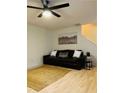 Inviting living room features a modern ceiling fan and comfortable leather sofa at 3466 Carriage Chase Rd, Atlanta, GA 30349