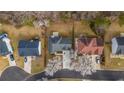 Aerial view of homes featuring well-manicured lawns and mature trees, showcasing neighborhood layout and curb appeal at 5706 Spring Mill Cir, Lithonia, GA 30038