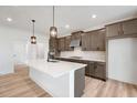 Bright kitchen with a central island, stainless steel appliances, and sleek dark cabinetry at 1465 Auburn Glen Rd, Dacula, GA 30019