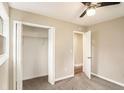 Cozy bedroom with a ceiling fan, neutral color palette, carpet flooring, and a walk-in closet at 1643 Pine Glen Cir, Decatur, GA 30035
