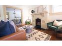 Inviting living room with a painted brick fireplace, hardwood floors, and contemporary decor at 2791 Pearl St, East Point, GA 30344