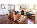 Cozy living room with hardwood floors, a brick fireplace, and stylish modern furniture at 2791 Pearl St, East Point, GA 30344