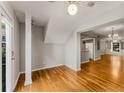 Bright entryway boasts hardwood flooring, neutral walls, and a view of the kitchen and dining area at 6700 Roswell Rd # 15B, Atlanta, GA 30328