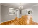 Spacious living area with hardwood floors, light-colored walls, and an open view to the kitchen at 6700 Roswell Rd # 15B, Atlanta, GA 30328