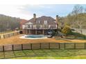 Expansive backyard with in-ground pool, covered patio, and verdant surroundings at 714 Billings Farm Ln, Canton, GA 30115