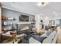 Inviting living room features a cozy fireplace and open floor plan to kitchen at 208 Village Overlook # J3, Canton, GA 30114
