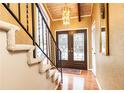 Inviting entryway with hardwood floors, elegant lighting, and an ornate staircase at 1511 Womack Rd, Atlanta, GA 30338