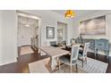 A gorgeous dining room area with dark wood flooring, open to kitchen and foyer at 2233 Peachtree Ne Rd # 1202, Atlanta, GA 30309