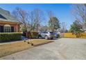 Wide driveway with parking for multiple cars, next to fenced yard at 906 Little Bear Cove Ne, Conyers, GA 30012