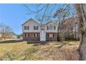 Traditional two-story home features a brick and siding exterior, with stairs leading to the front door at 158 Ashwood Drive Dr, Dallas, GA 30157