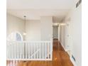 Upstairs hallway featuring hardwood floors and natural light from the half round window at 158 Ashwood Drive Dr, Dallas, GA 30157