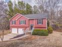 Traditional exterior elevation, with red siding, two car garage and landscaped front yard at 60 Kyler Way Way, Dallas, GA 30157