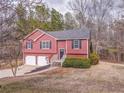 Traditional exterior elevation, with red siding, two car garage and landscaped front yard at 60 Kyler Way Way, Dallas, GA 30157