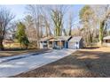 Charming blue one-story home features a covered porch and attached single-car garage at 1981 Lindsey Ln, Decatur, GA 30035