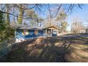 View of a charming blue one-story home with a covered front porch at 1981 Lindsey Ln, Decatur, GA 30035