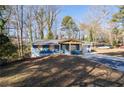 A cozy one-story blue home with a charming covered front porch and driveway at 1981 Lindsey Ln, Decatur, GA 30035