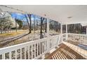 Inviting covered front porch with white railings and wood decking with backyard views at 2570 Curtis Sw Rd, Marietta, GA 30064