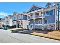 Street-level view of the house featuring a double porch and a stone foundation at 5293 Hearthstone St, Stone Mountain, GA 30083