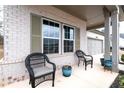 Comfortable seating on front porch with large windows, enhancing curb appeal at 5650 Bergeson Way, Cumming, GA 30028