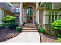 Grand front entrance boasting stone accents, an arched doorway, and a manicured landscape at 1617 Windsor Ne Pkwy, Brookhaven, GA 30319