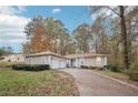 Charming single-story home with a two-car garage and a long driveway in wooded neighborhood at 7463 Lerose Dr, Jonesboro, GA 30236