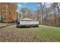 Spacious front yard with green grass and trees surrounding a charming single-story home at 7463 Lerose Dr, Jonesboro, GA 30236