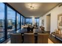 Bright and airy dining room with modern lighting and views of the city skyline through large windows at 788 W Marietta Nw St # 1302, Atlanta, GA 30318
