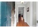 View of foyer with hardwood floors, stairs, and doorway to the living room at 1540 Cedar Bluff Trl, Marietta, GA 30062