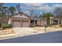 Inviting brick home with a well-kept lawn, two-car garage, and classic curb appeal at 104 Big Meadows Dr, Canton, GA 30114