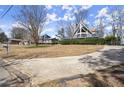 A-frame home with a deck, surrounded by a spacious front yard and a driveway leading to the house at 1364 Tsali Trl, Morrow, GA 30260