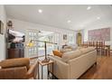 Inviting living room with hardwood floors, ample seating, and large windows leading to a sunroom at 6875 Sunny Brook Ln, Atlanta, GA 30328
