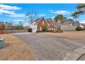 View of the home showcasing an expansive driveway and partial backyard at 1715 Branchwood Ct, Powder Springs, GA 30127