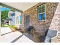 Inviting covered porch with brick facade, comfortable seating, and a welcoming entrance at 1947 Thomasville Estate Dr, Atlanta, GA 30315