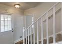 Bright entryway featuring a staircase with white railing and tiled steps and white door at 2134 Elinwood Dr, Atlanta, GA 30344